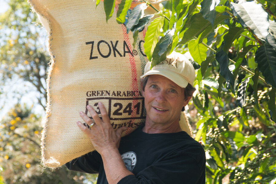 Jeff at coffee origin with bag on shoulder